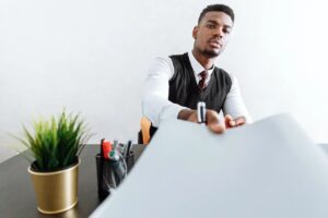 A young businessman holding a document, with the intention to file a moving complaint.