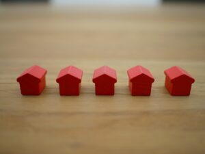 A line of small red houses on a table.