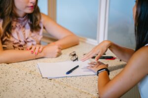 Two people talking before sharing ownership of a home.