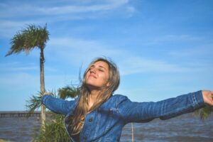 A happy woman thinking about ways to recover and thrive after bankruptcy.