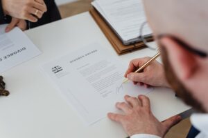 A person signing divorce papers.