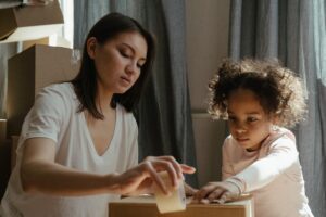 A mother and daughter packing.