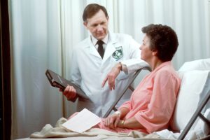 Doctor talking to an older woman after a slip and fall accident.