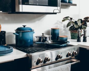 A stove with blue pots on top.
