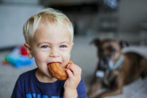 A cute baby and a dog.