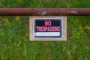 “No trespassing” signs can help so that in case a trespasser gets hurt on your property 