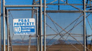 a gate with a “no trespassing” sign 