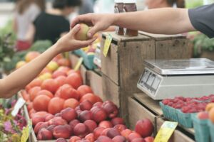 Person giving fruit to another person