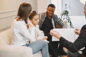 Family of three on a counseling session about the impact of relocation on child custody agreements