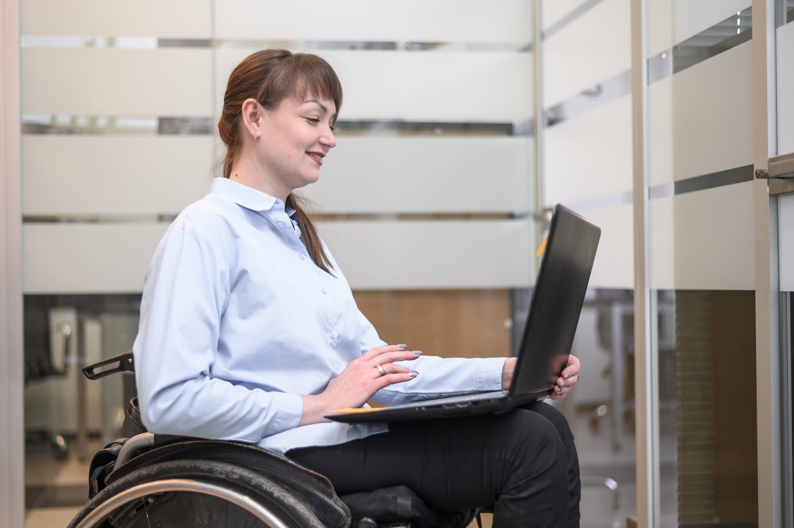 Lady with laptop in a wheelchair