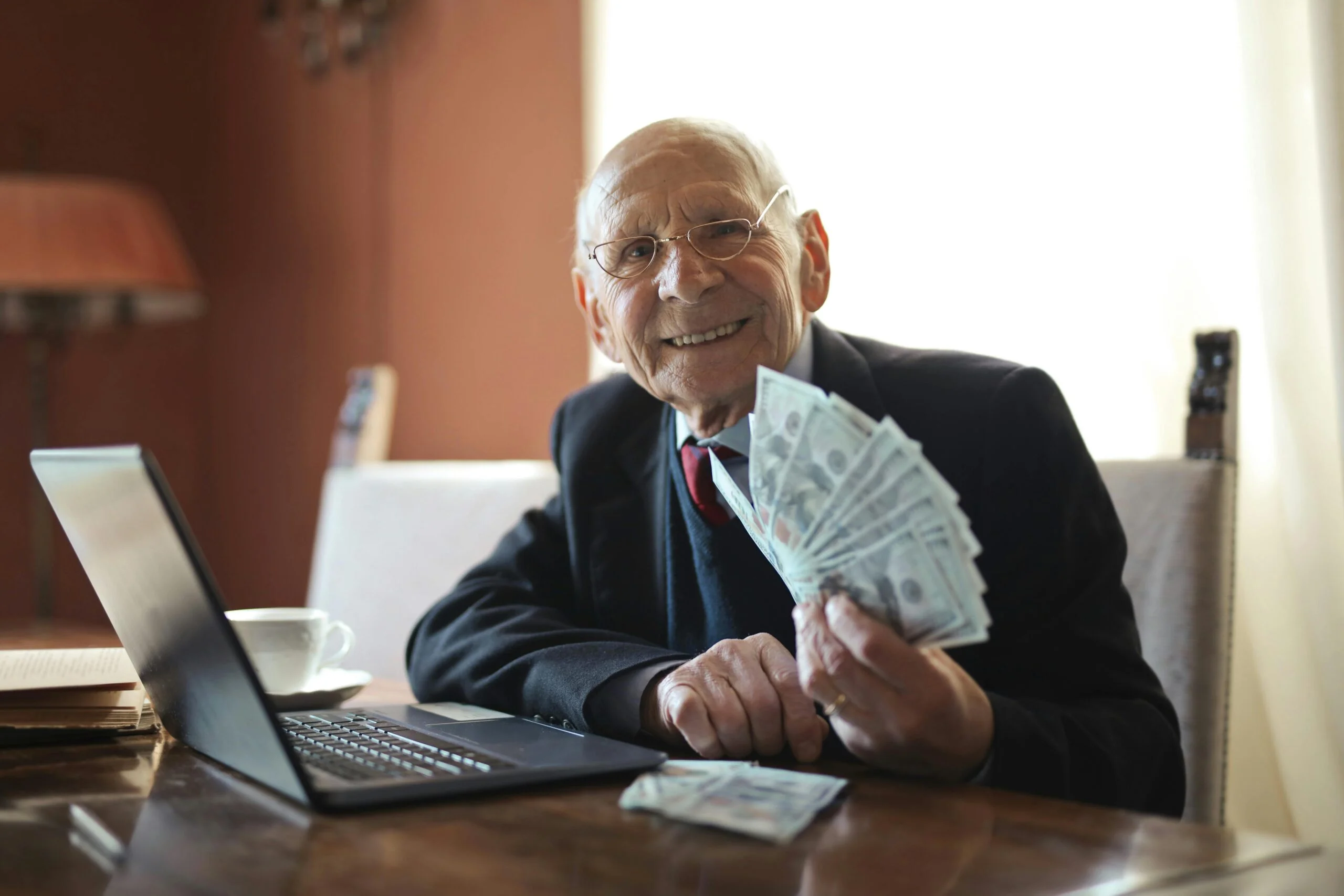 Old man holding a lot of cash.