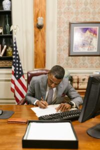 Man writing at a desk.