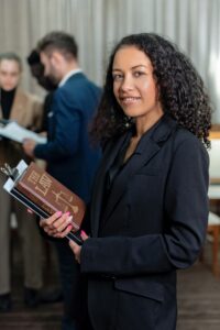 Lady holding a law book.